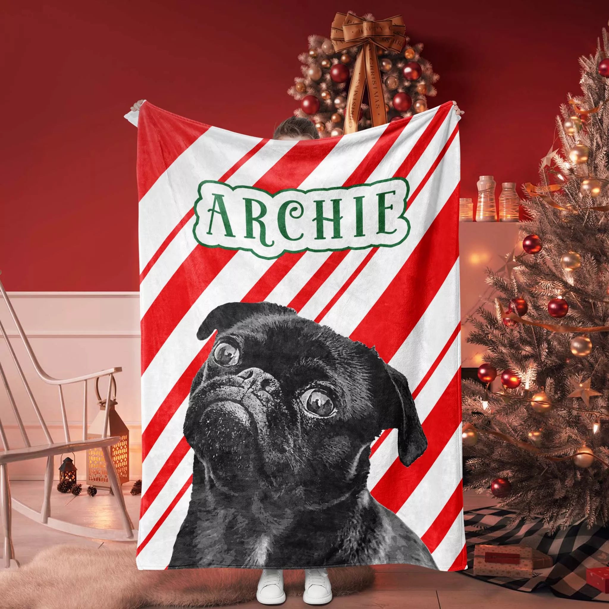 Personalized Pug dog blanket with a black pug and name 'Archie' on a candy cane pattern background.