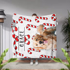 Person holding a blanket with a Golden Retriever dog and candy canes design, with 'Grace' printed on it.