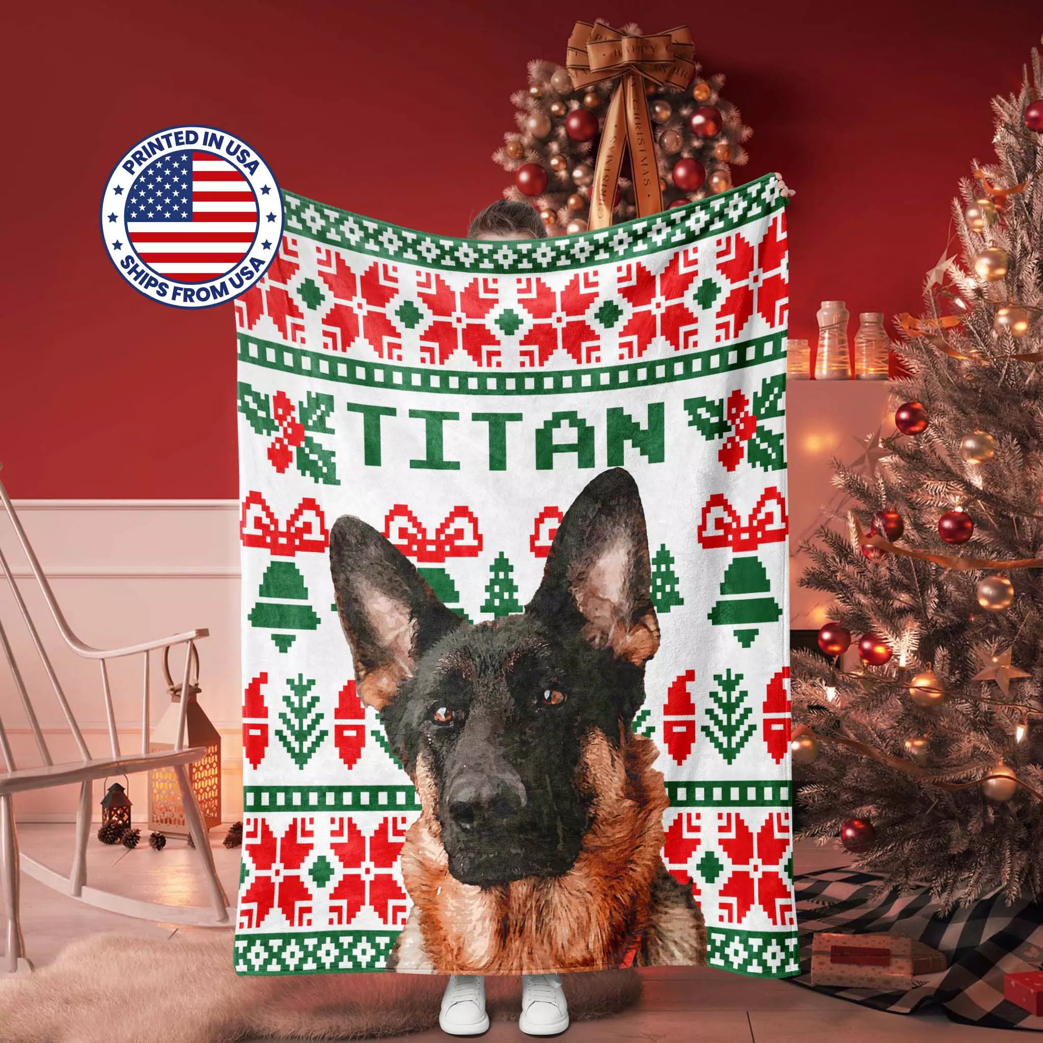Christmas ugly sweater dog blanket with 'TITAN' printed on it, Christmas tree and decorations in the background.