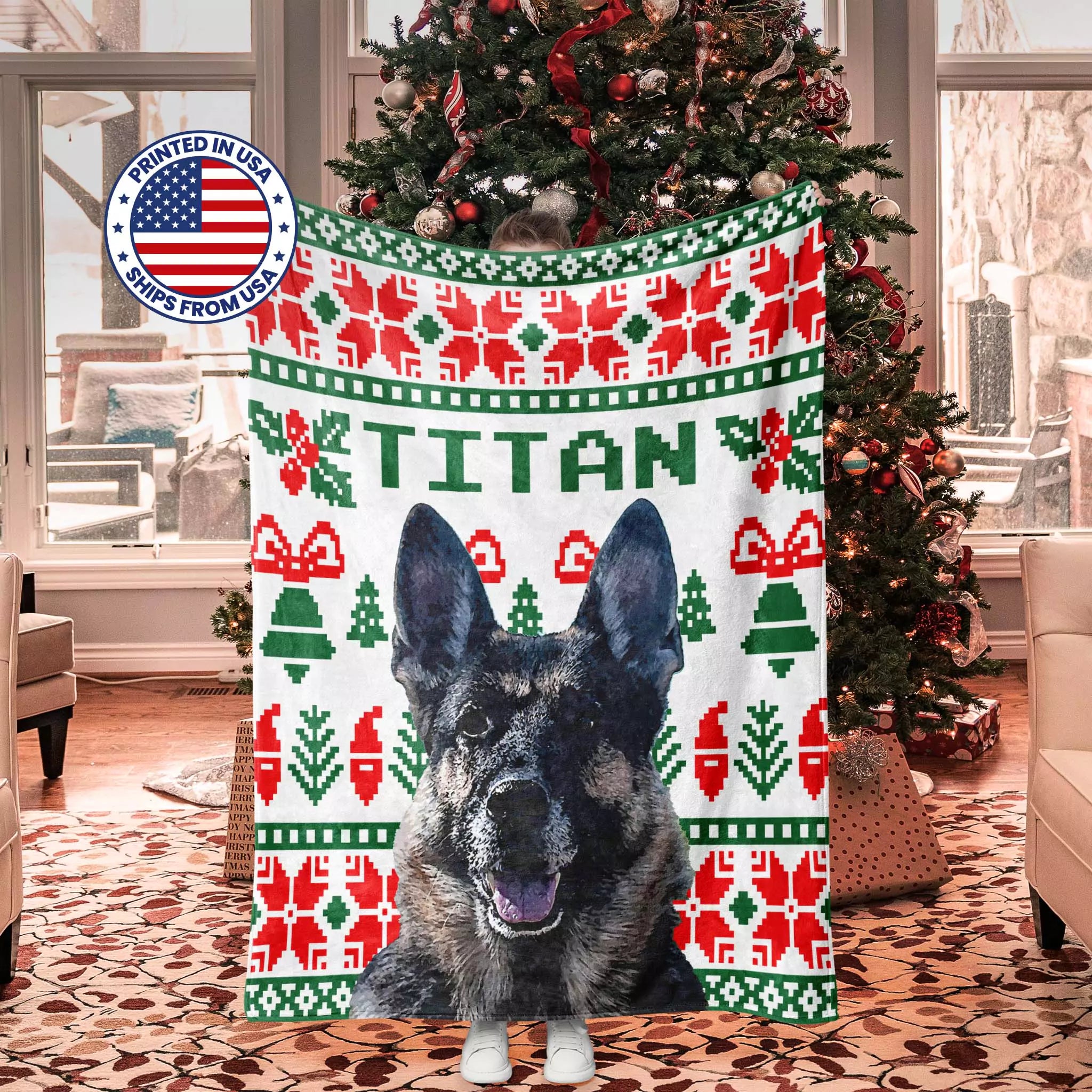 Dog blanket with 'TITAN' printed on it, featuring Christmas ugly sweater patterns, in a room with a decorated Christmas tree.