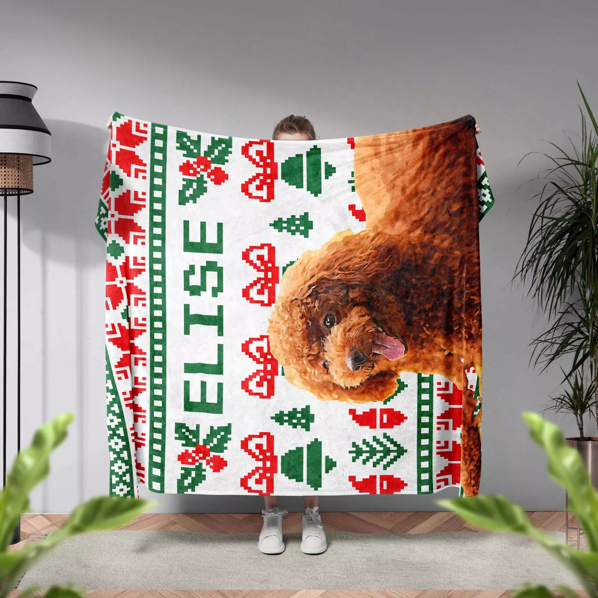 Person holding a Christmas Ugly Sweater Customized Dog Blanket with Poodle with a dog's face and Christmas patterns, with 'Elise' printed on it.