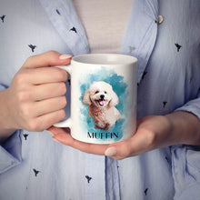 Person holding a Poodle mug with a dog illustration and 'MUFFIN' text, wearing a light blue pajama set.