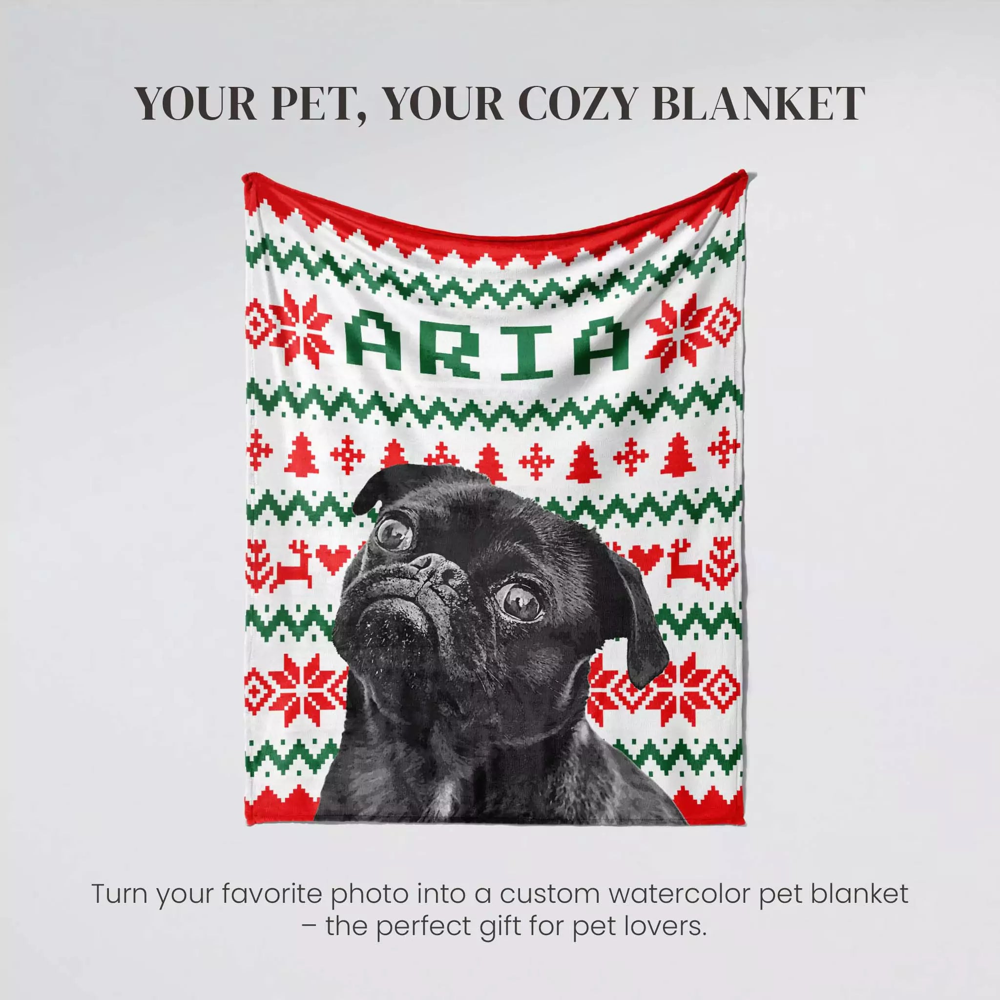 Dog in a custom watercolor dog blanket with monogrammed 'ARIA' text on a gray background