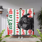Person holding a festive dog blanket with a black dog's face and 'Aria' monogrammed name text.