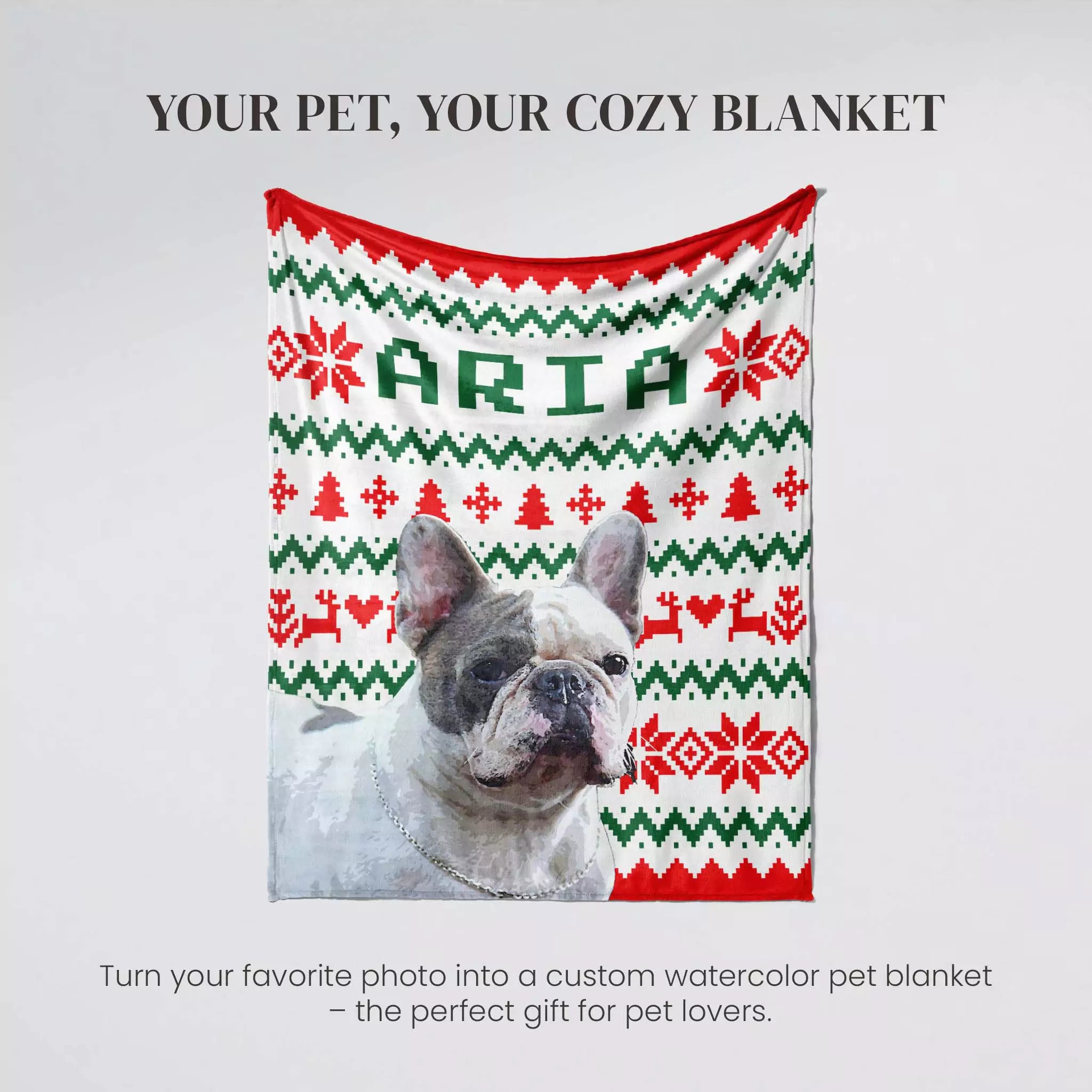 Dog under a personalized dog blanket with 'ARIA' on a light gray background