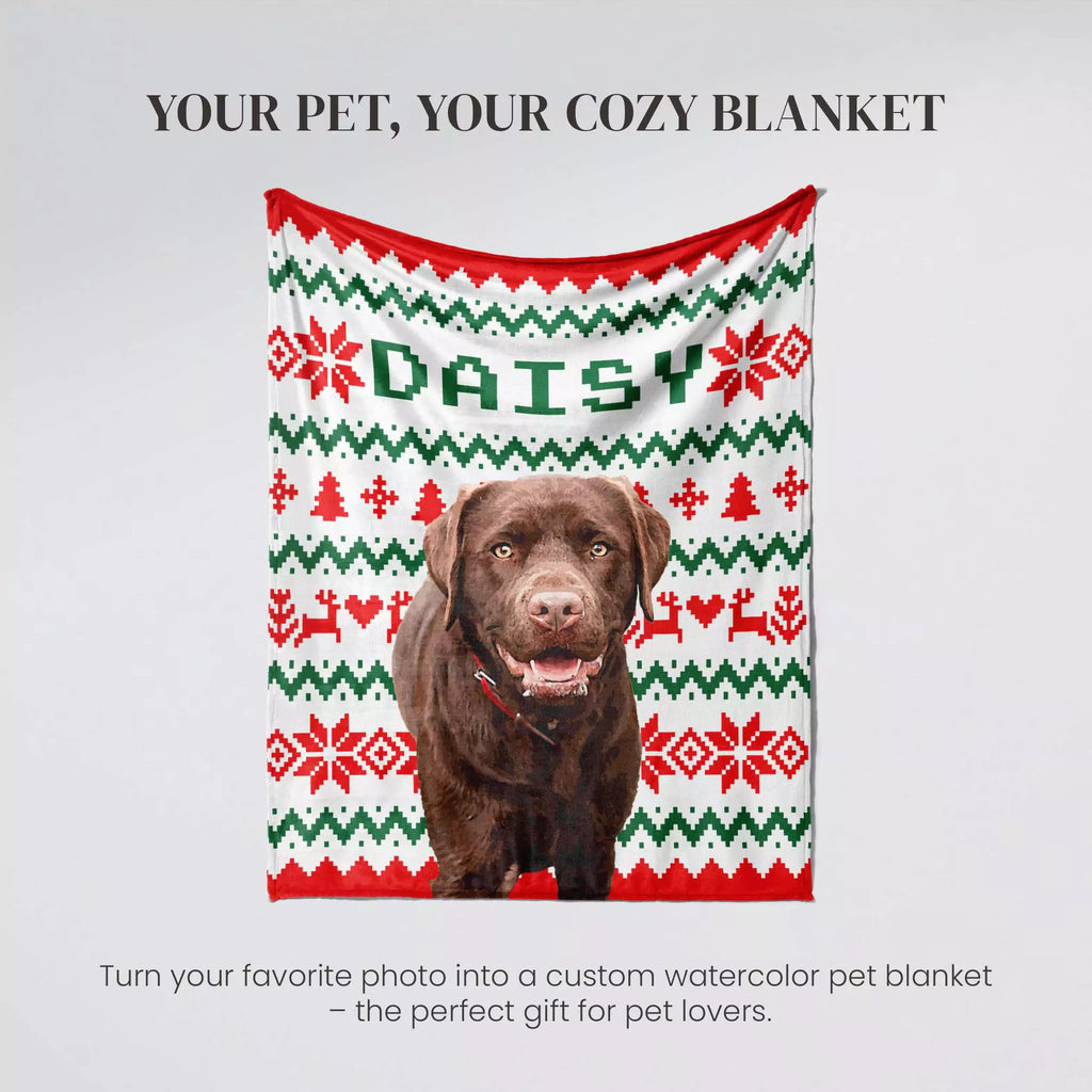 Dog wearing a personalized dog blanket with 'DAISY' on a gray background