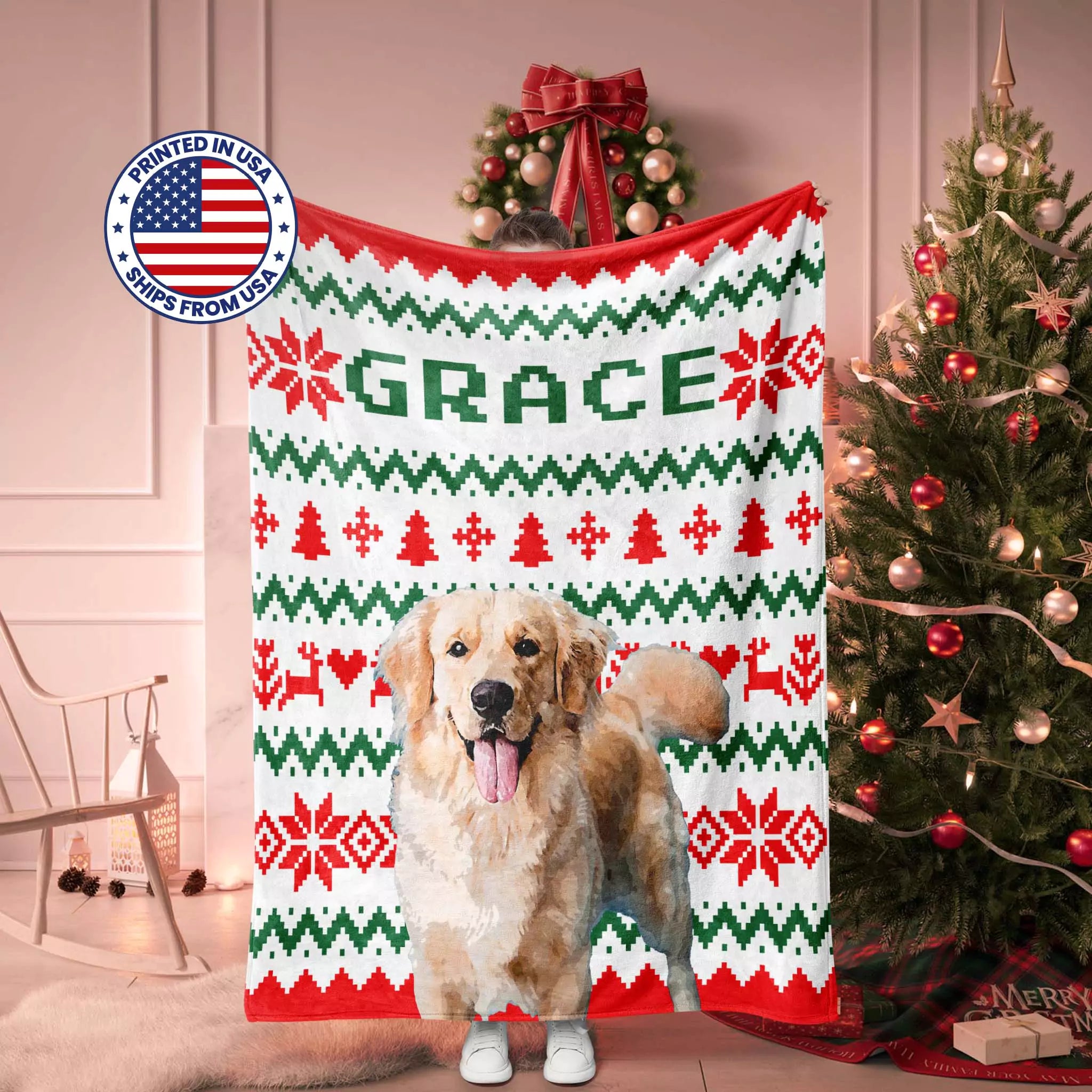 Golden Retriever Dog standing in front of a Christmas-themed blanket with 'GRACE' printed on it, surrounded by festive decorations.
