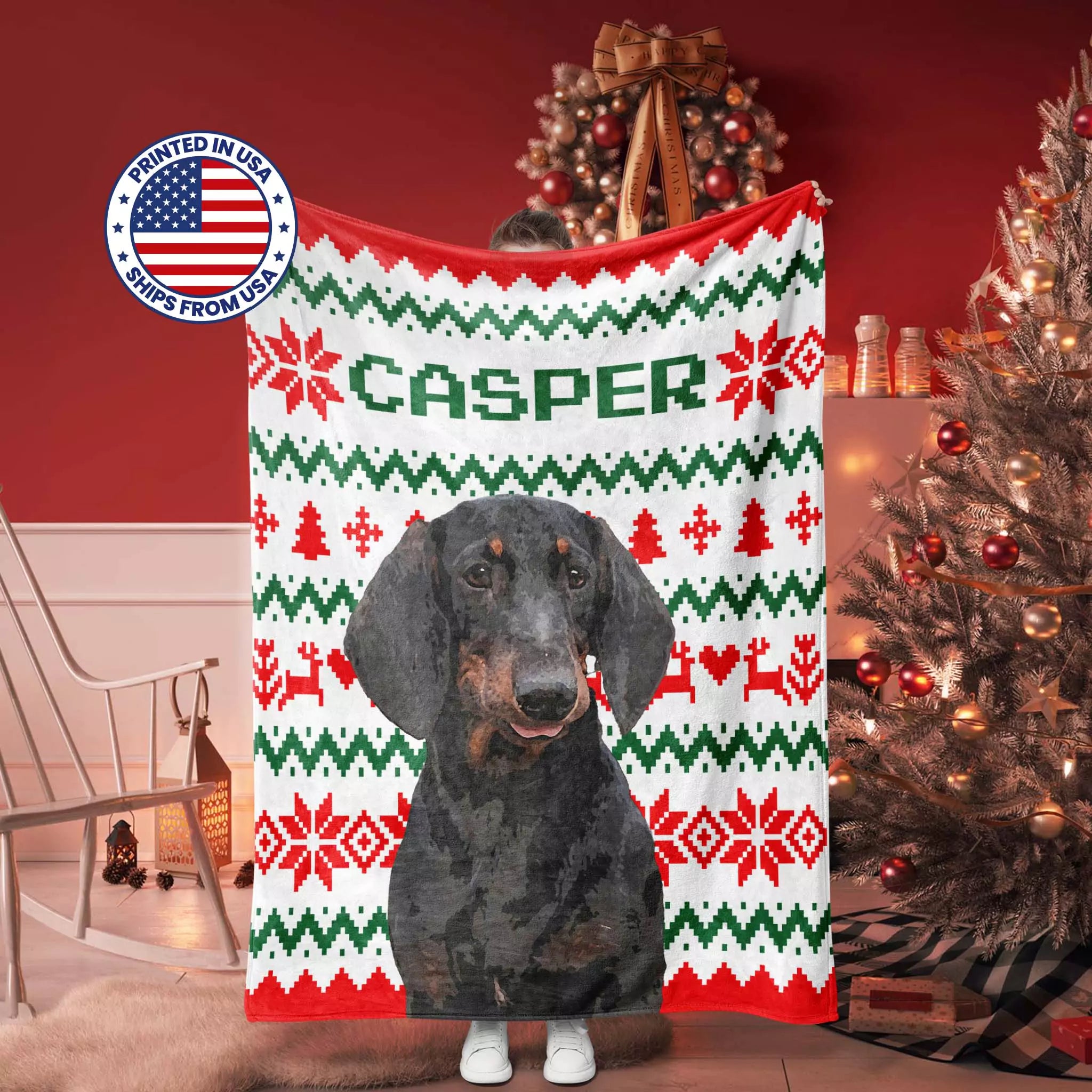 Dachshund Dog blanket with 'Casper' printed on it, featuring a Christmas-themed ugly sweater pattern, in a room with a Christmas tree.